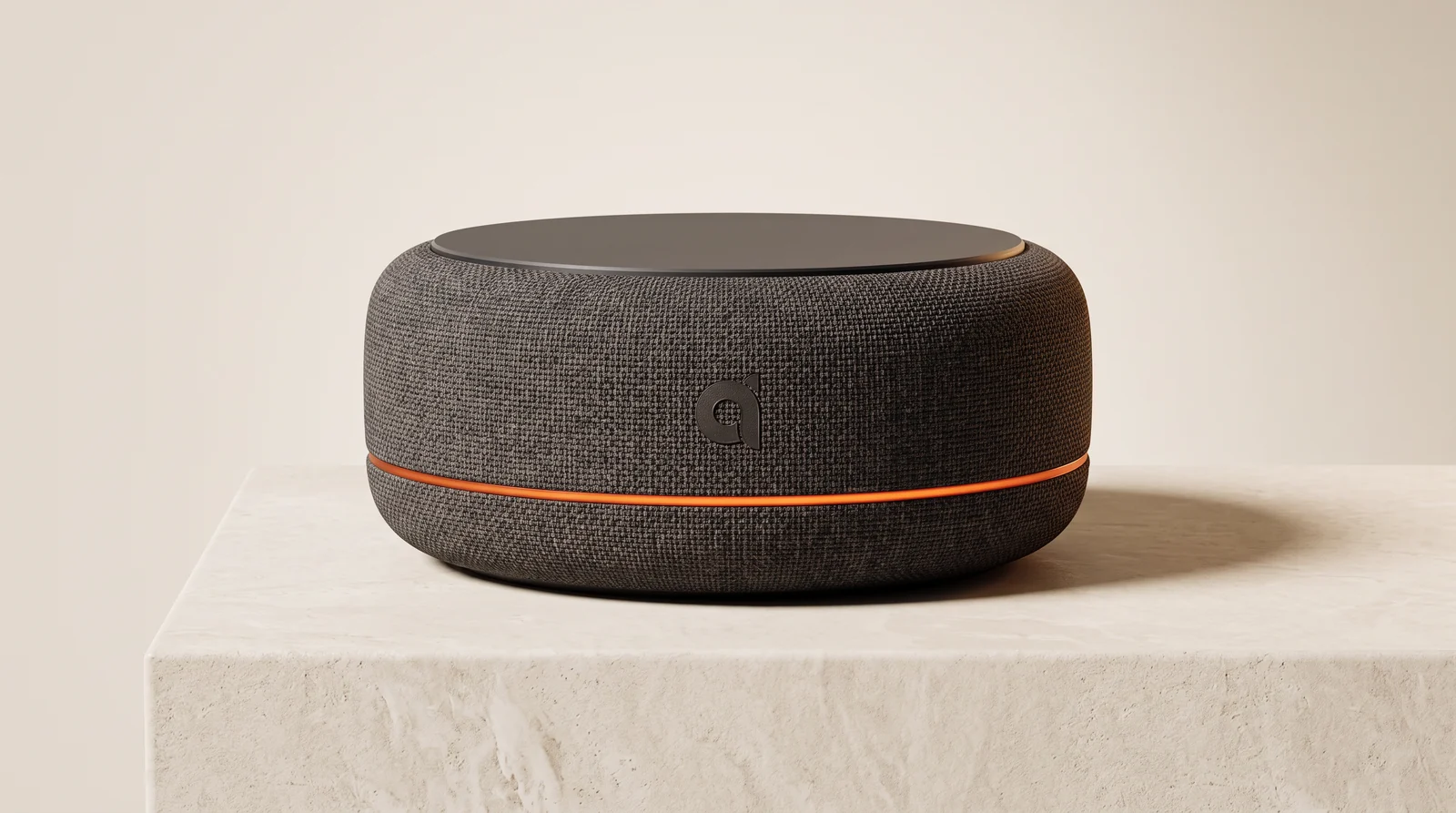 Adomo Relay, a charcoal fabric smart speaker with an orange light ring, photographed on a limestone plinth